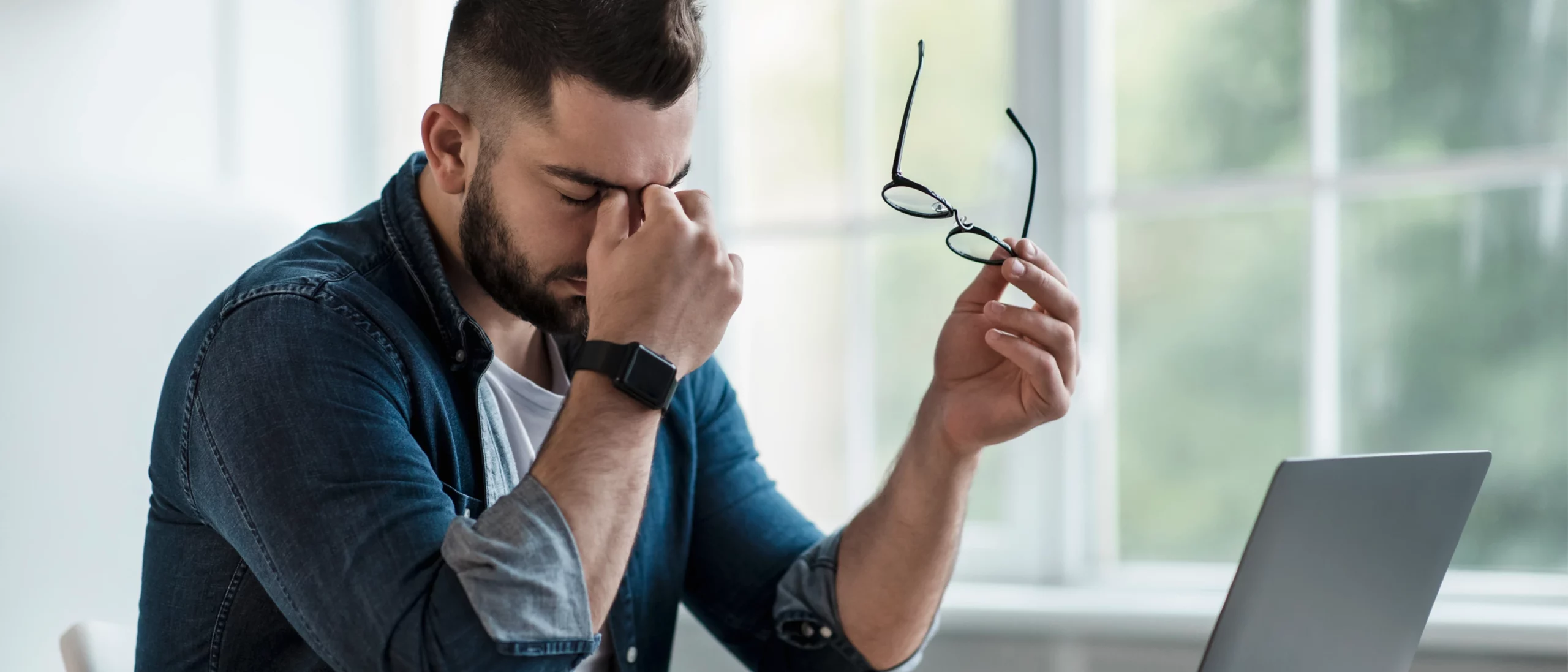 exhausted man in front of computer