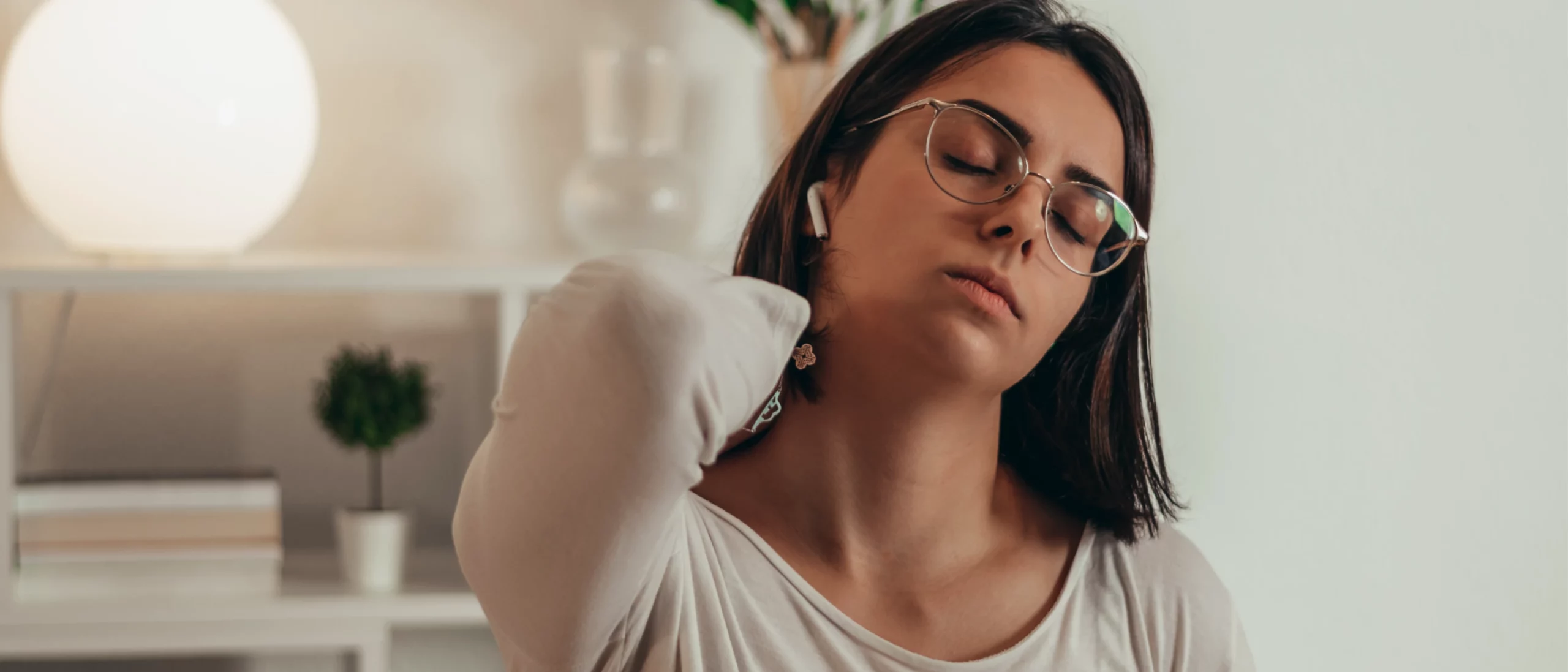 woman rubbing neck