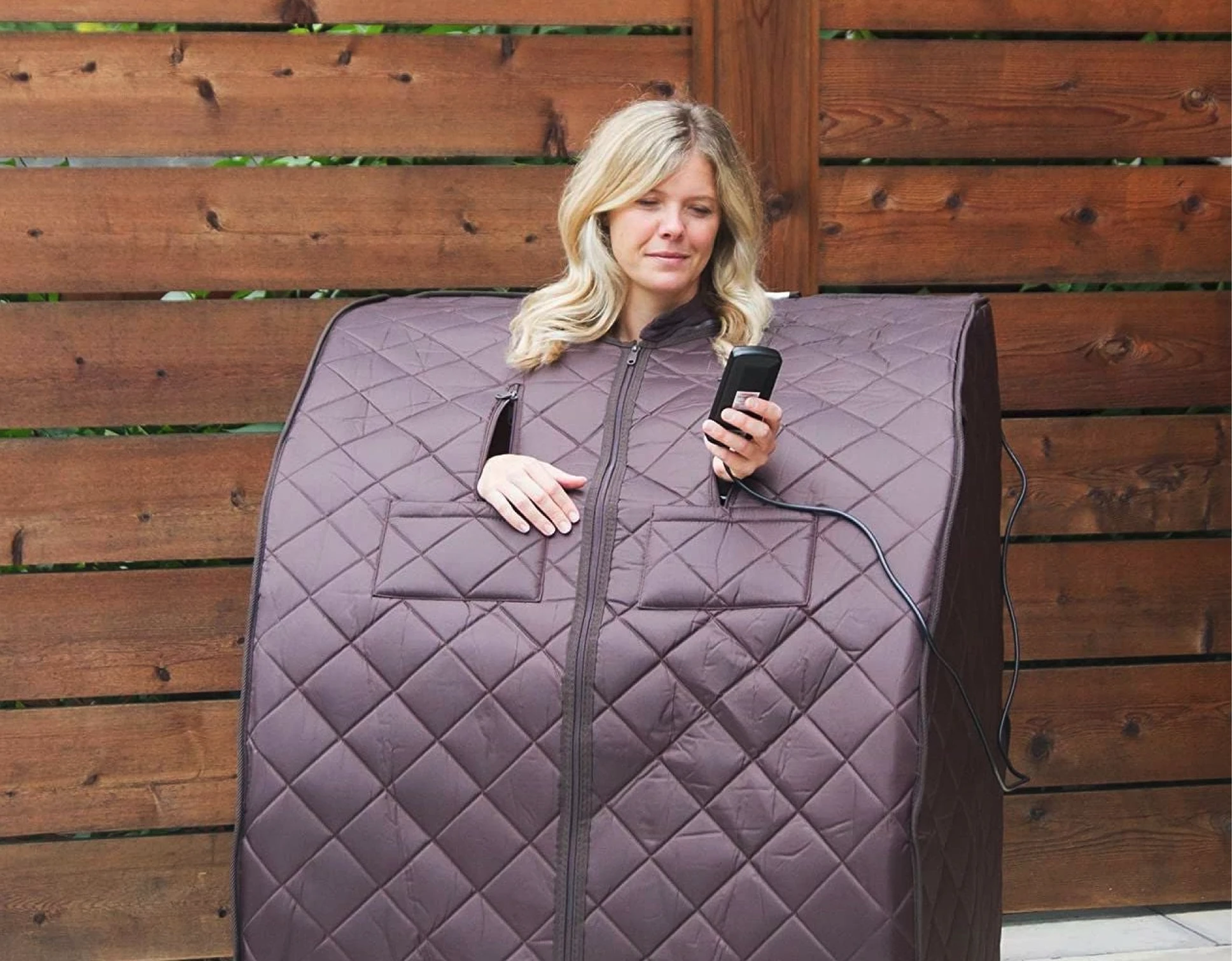 woman using a portable sauna outside