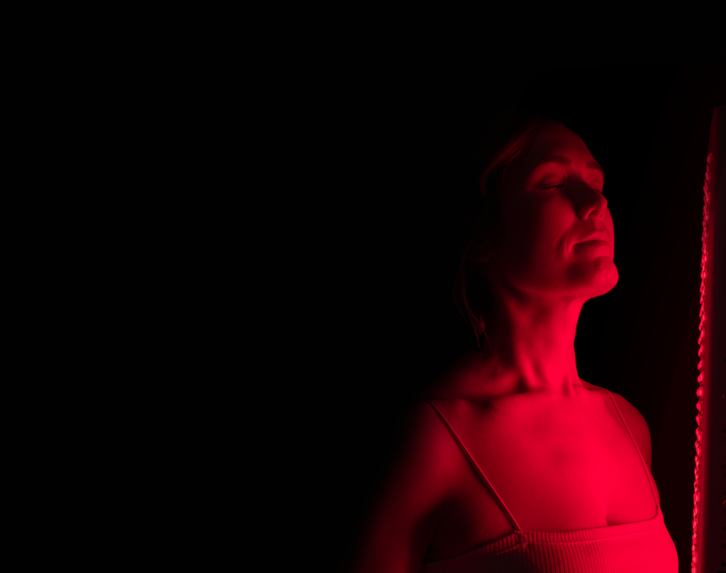 woman with her eyes closed standing in front of a red max