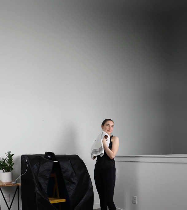 woman next to closed foldaway sauna