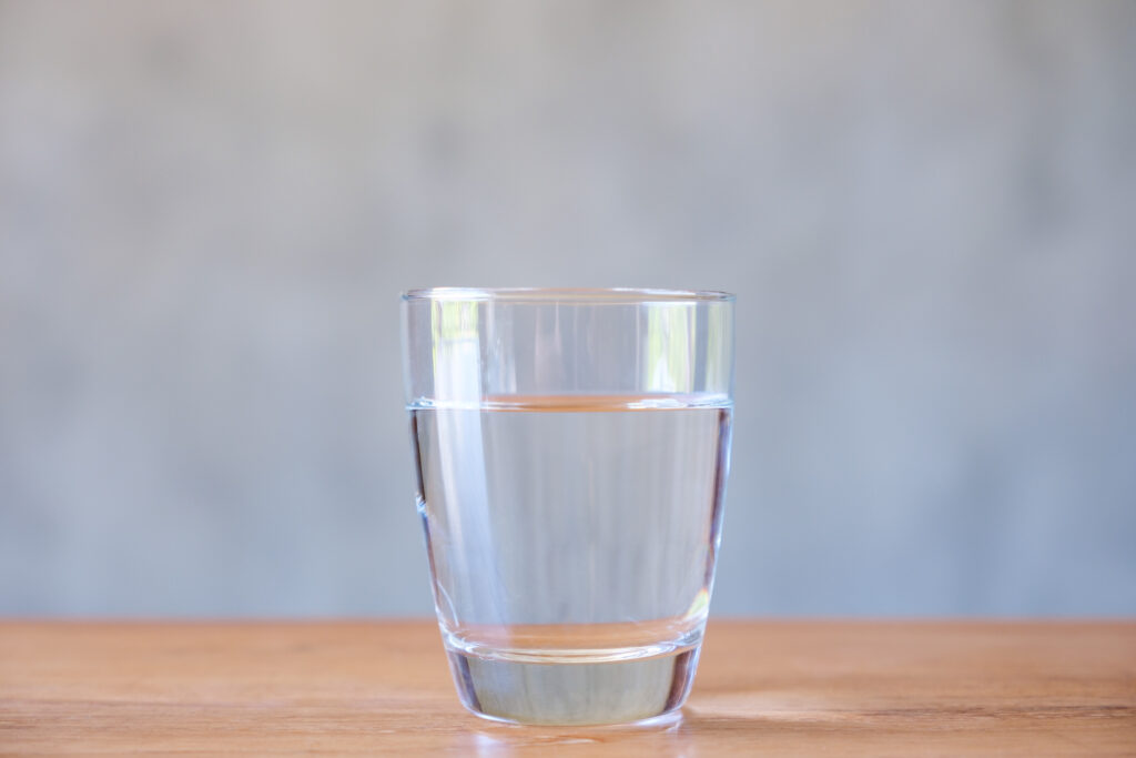 Glass of water on wooden table