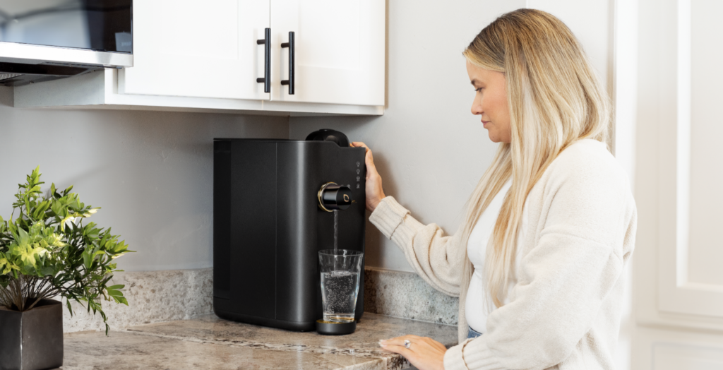 lady in a kitchen with the over-counter water machine