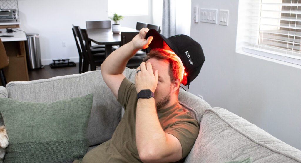 man wearing red light cap